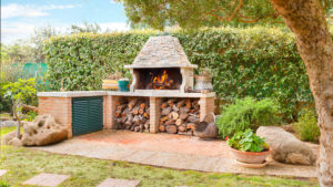 have an outdoor kitchen with a wood-fired pizza oven